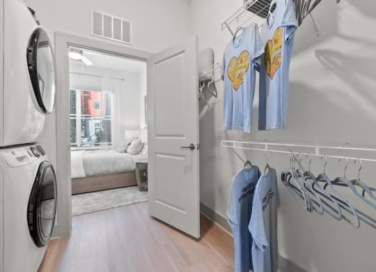 a washer and dryer in a room with a bedroom in the background at Tapestry West, Richmond, VA