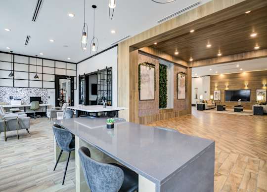 A modern kitchen with a dining table and chairs.