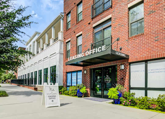 A leasing office is located in a brick building.