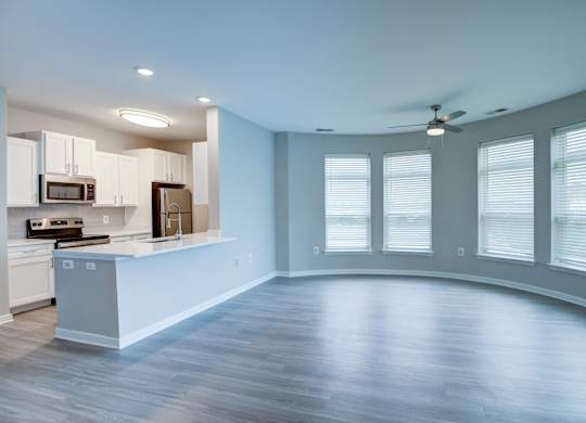 A spacious kitchen with a countertop and cabinets.