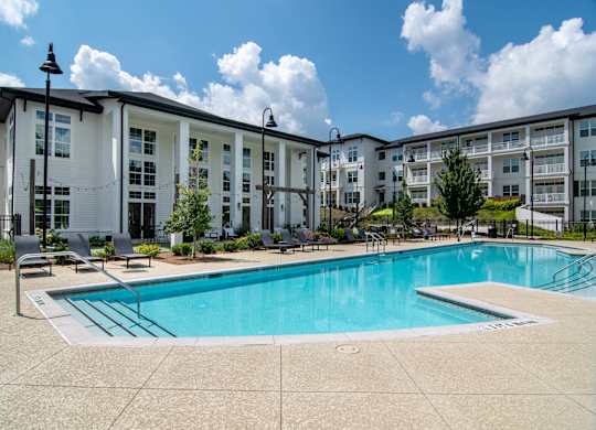 A swimming pool in front of apartment buildings.