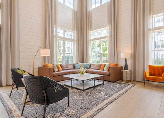 A living room with a sofa, two chairs, and a coffee table.