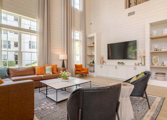 A living room with a brown chair and a white couch.
