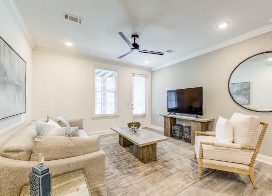 a living room with a couch and a tv at Residences at 393 North Apartments, Santa Rosa Beach, FL