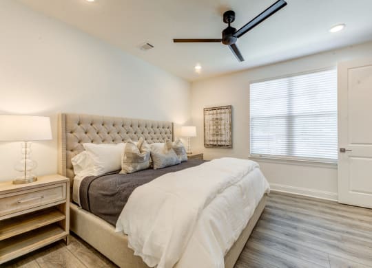 the master bedroom has a large bed and a ceiling fan at Residences at 393 North Apartments, Santa Rosa Beach, Florida