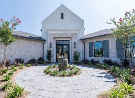 the front of a house with a courtyard and a fountain at Residences at 393 North Apartments, Santa Rosa Beach, FL, 32459