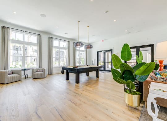 a living room with a pool table in the center of it at Residences at 393 North Apartments, Santa Rosa Beach, FL, 32459