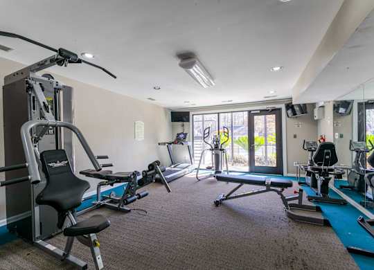 A well-equipped gym with a variety of exercise machines.