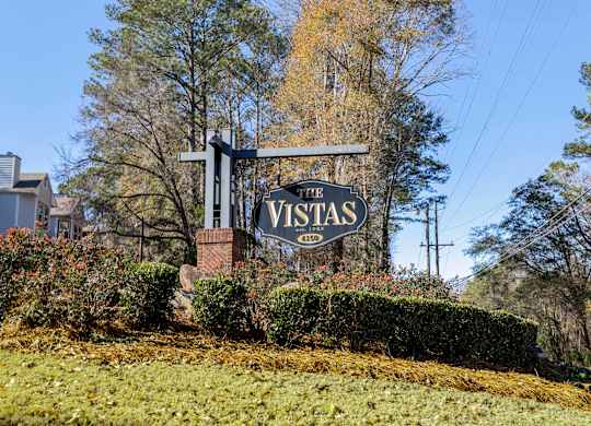A sign that says Vistas in front of a building.