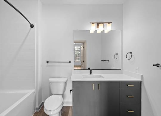 A white toilet sits next to a sink in a bathroom.