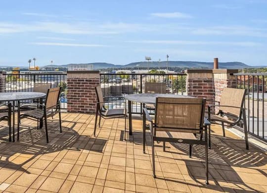 a patio with tables and chairs on a balcony at 17 Broad, Tennessee, 37408