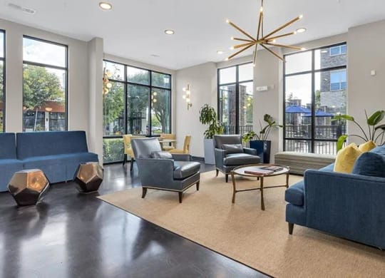 a large living room with blue couches and chairs at 17 Broad, Tennessee