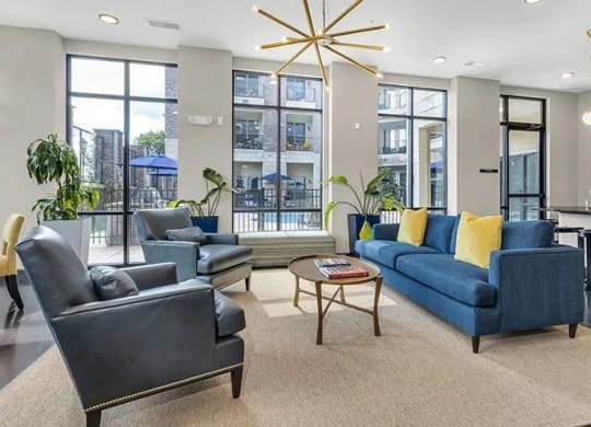 a living room with couches chairs and a table at 17 Broad, Chattanooga Tennessee
