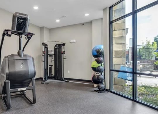 a home gym with exercise equipment and a window at 17 Broad, Chattanooga
