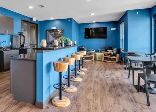 a kitchen and dining room with a bar and tables at 17 Broad, Chattanooga, TN 37408