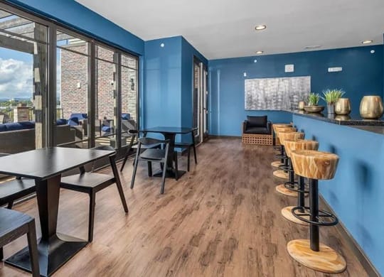 a dining room with tables and chairs and a balcony at 17 Broad, Chattanooga Tennessee