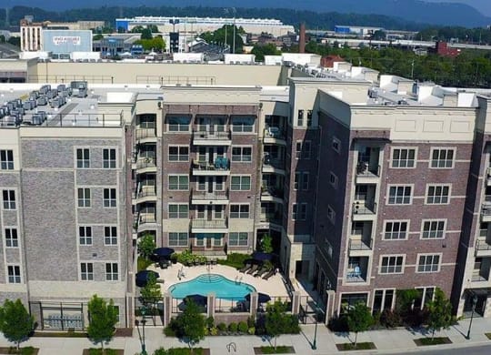 an aerial view of a large building with a swimming pool at 17 Broad, Chattanooga Tennessee