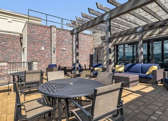 a patio with a table and chairs on a roof at 17 Broad, Chattanooga, 37408