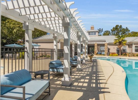 a swimming pool with lounge chairs and a white trellis at Marina Point, Chattanooga Tennessee