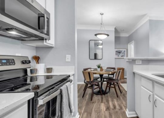 a kitchen with a sink and a stove and a table at Marina Point, Chattanooga