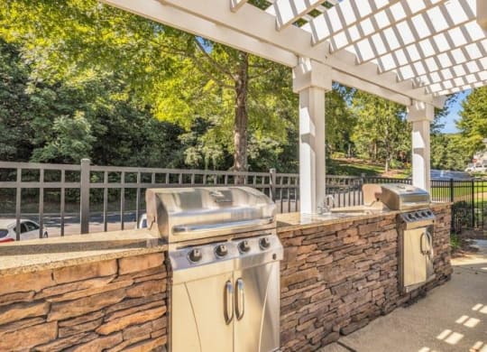 a patio with a barbecue grill and a stone wall at Marina Point, Chattanooga, 37415