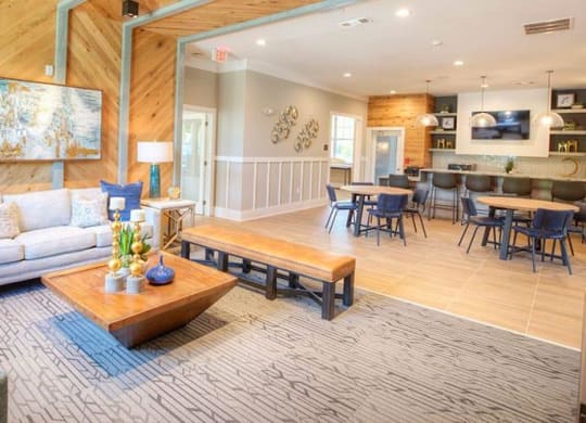 a living room and dining room with a couch and tables  at Lullwater at Big Ridge, Hixson
