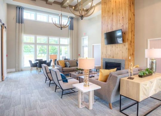 a living room with a bunch of tables and chairs  at Lullwater at Big Ridge, Hixson, TN