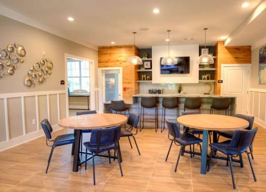 a dining room with tables and chairs and a kitchen  at Lullwater at Big Ridge, Hixson, Tennessee