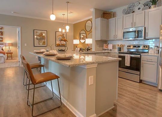 a kitchen with a center island and stainless steel appliances  at Lullwater at Big Ridge, Hixson