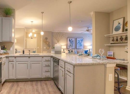 a large kitchen with white cabinets and a counter top  at Lullwater at Big Ridge, Hixson, TN, 37343