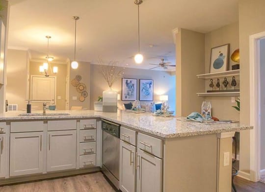 a kitchen with white cabinets and granite counter tops  at Lullwater at Big Ridge, Hixson, TN
