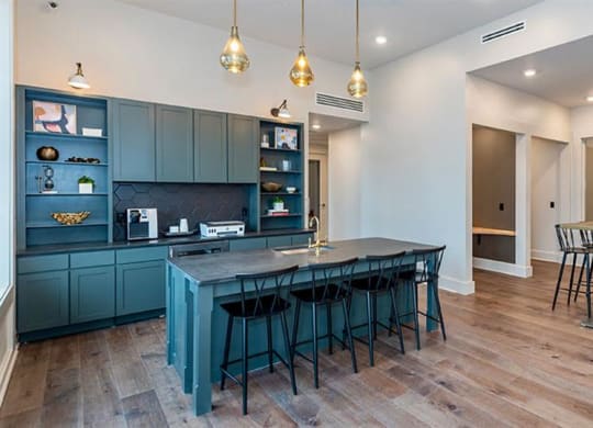 a kitchen and living room with a blue table and chairs at Livingston Flats Apartments, Chesterfield, Virginia