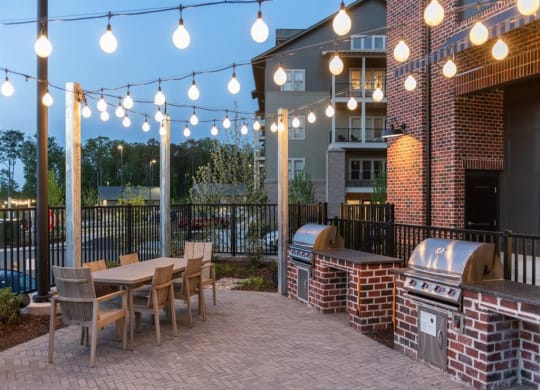 a patio with a grill and a table and chairs at Livingston Flats Apartments, Chesterfield, VA, 23832