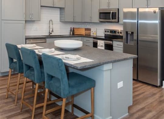 a kitchen with a center island and a stove top oven at Livingston Flats Apartments, Chesterfield, VA