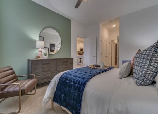 a bedroom with a bed and a ceiling fan at Flats at West Broad Village, Virginia, 23060