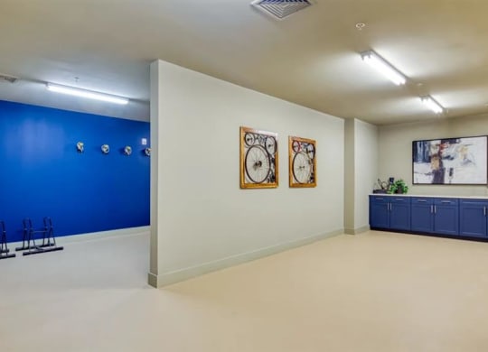 a room with a blue wall and two clocks on the wall at Artistry at Winterfield Apartments, Midlothian ,23112