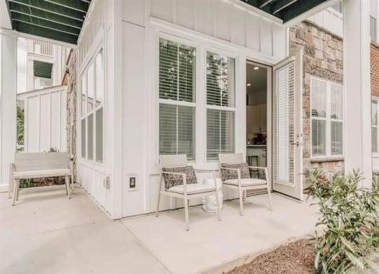 a porch with two chairs and a bench at Artistry at Winterfield Apartments, Midlothian, VA, 23112