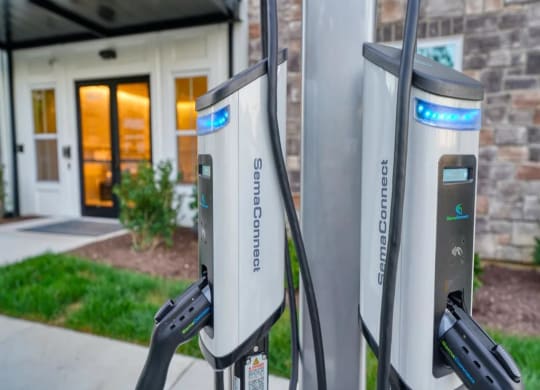 a couple of gas pumps sitting in front of a building at Artistry at Winterfield Apartments, Midlothian, VA