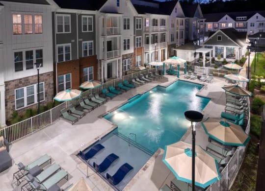 an aerial view of a resort style pool with lounge chairs and umbrellas at Artistry at Winterfield Apartments, Midlothian, VA