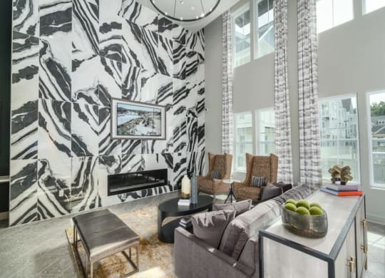 a living room with a large couch and a fireplace at Artistry at Winterfield Apartments, Midlothian ,23112