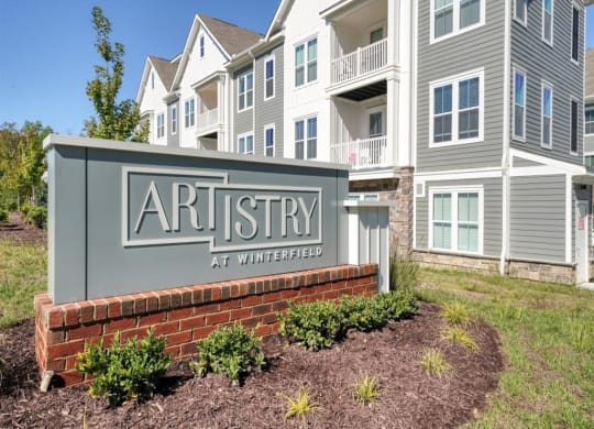 a building with a sign that says artistry at winfield at Artistry at Winterfield Apartments, Midlothian