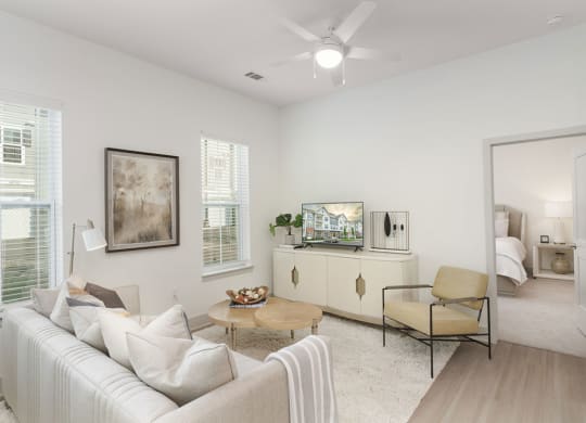 a living room with white walls and a ceiling fan at Artistry at Winterfield Apartments, Midlothian ,23112