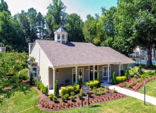 a white building with a cupola and a sign in front of it at Hunters Chase Apartments, Midlothian, VA, 23112