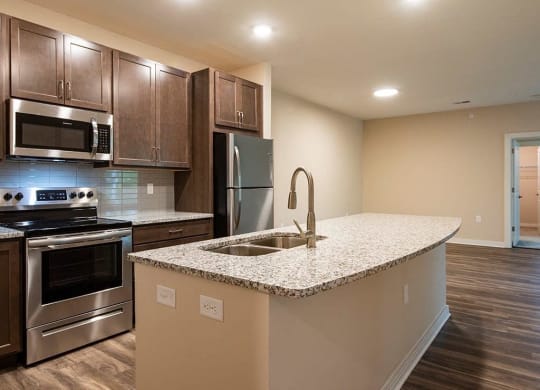 a kitchen with a large island and stainless steel appliances  at Sapphire at Centerpointe, Midlothian, 23114