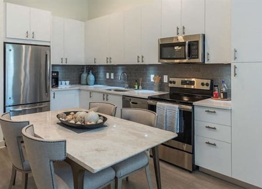 Stylish white cabinetry with stainless appliance package at 2000 West Creek Apartments, Virginia, 23238
