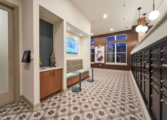 a hallway with a bench and a wall mounted tv at Tapestry West, Richmond, VA