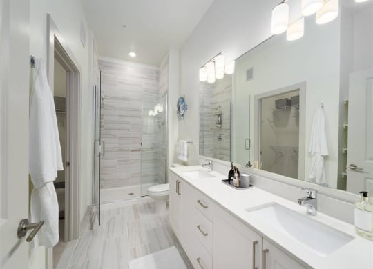 a bathroom with two sinks and a shower at Tapestry West, VA 23230