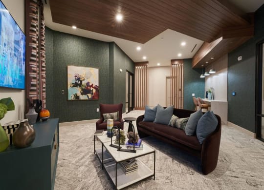 a living room with a brown couch and a white coffee table at Tapestry West, Richmond