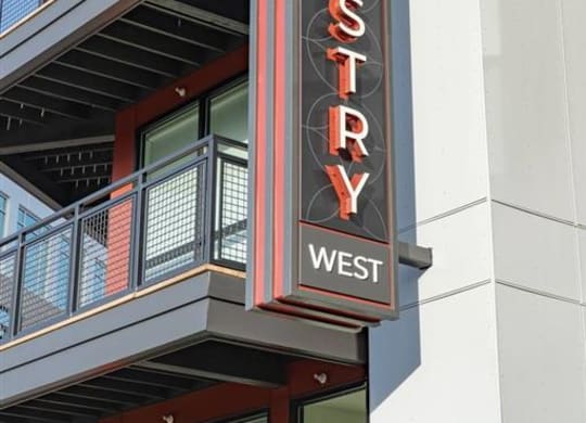 a building with a sign on the side of it at Tapestry West, Richmond, VA