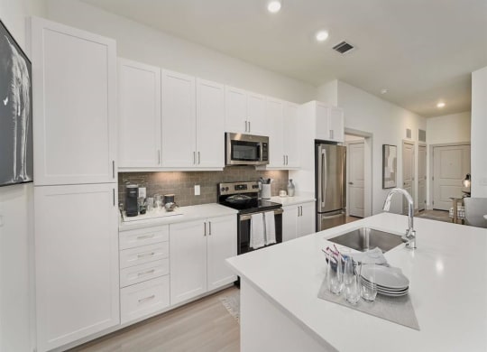 a white kitchen with a white counter top at Tapestry West, Richmond
